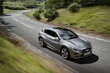 Imagen del Infiniti Q30 en acción, destacando su perfil lateral y diseño aerodinámico.