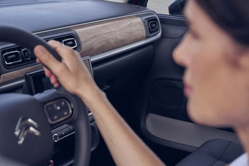 Mujer interactuando con el sistema de control táctil del Citroën C3.