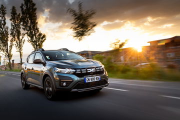 Vista dinámica del Dacia Sandero 2024 en movimiento al atardecer.