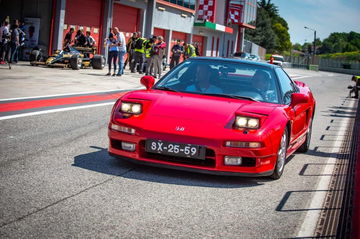 Honda NSX rojo capturado en el trazado del circuito, homenaje al legado de Senna.