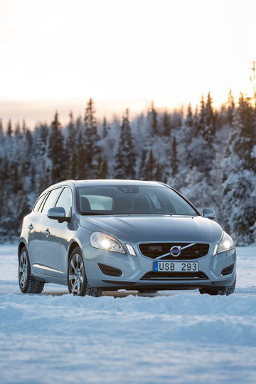 Vista frontal y lateral de un Volvo V60 D6 Plug-in Hybrid en un entorno nevado.