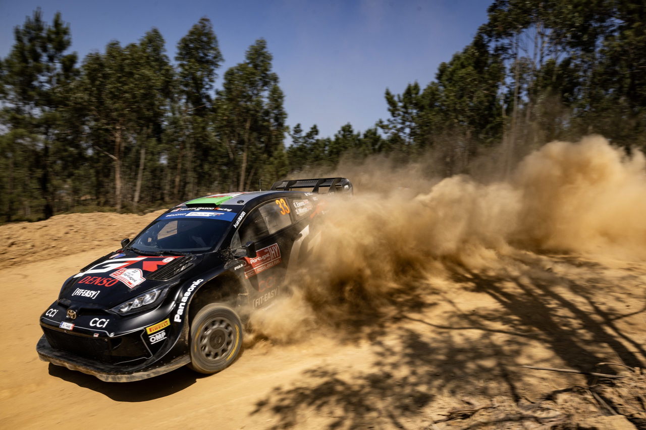 Vehículo de rally derrapando en una curva con habilidad y velocidad.