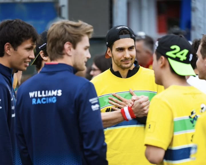 Esteban Ocon conversando con personal de equipos de F1.