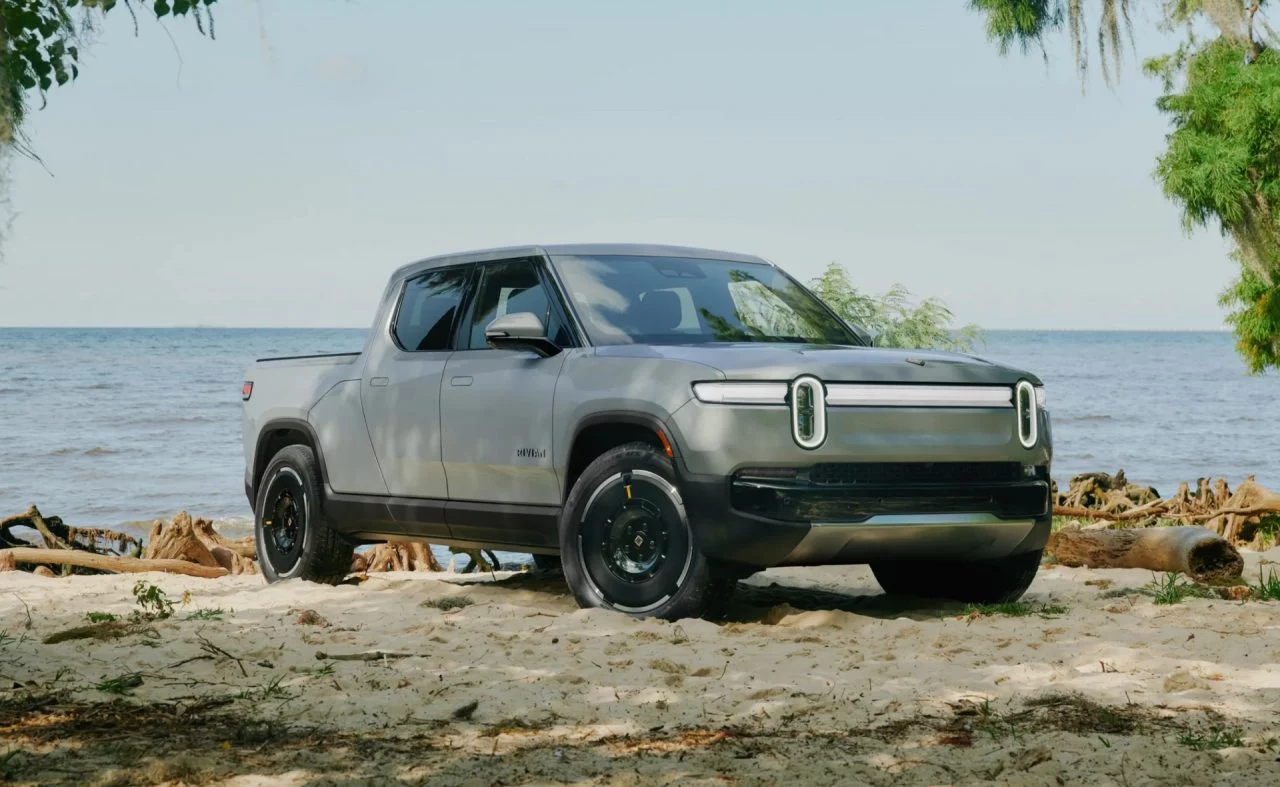 Vista lateral del Rivian R1T, reflejando su capacidad todoterreno y diseño robusto.