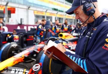 Adrian Newey concentrado en datos técnicos junto al monoplaza de F1