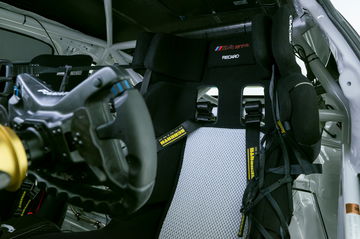 Vista del puesto de conducción del BMW M4 GT4 con volante de carreras.