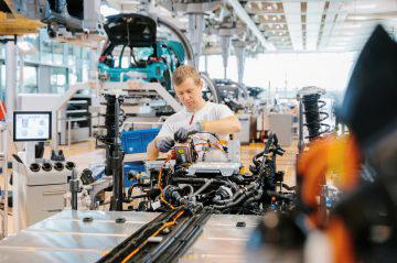 Vista parcial de la línea de montaje de Volkswagen con un empleado trabajando.