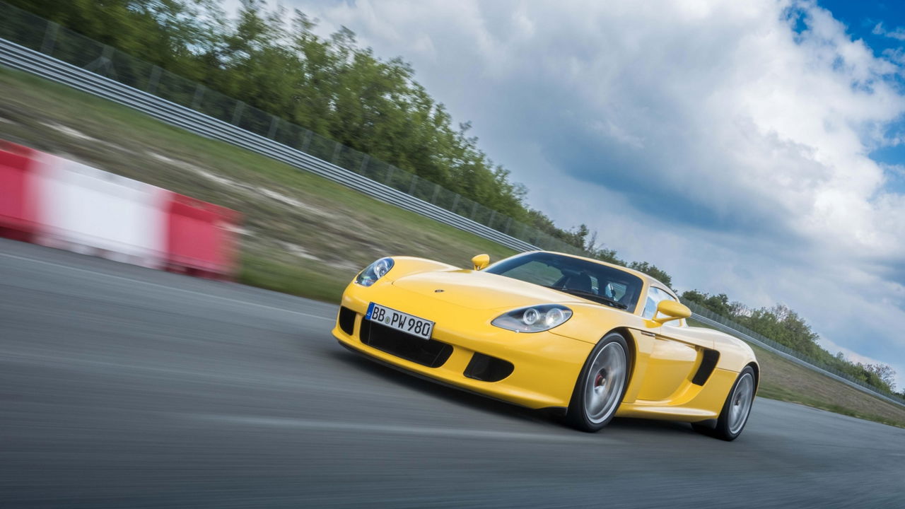 Vista dinámica del Porsche Carrera GT en acción, destacando su fluidez y deportividad.