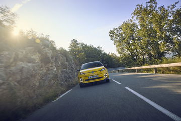 Vista dinámica del Renault 5 en carretera, evocando su legado con un diseño moderno.