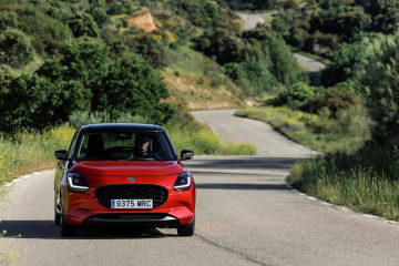 Vista dinámica del Suzuki Swift 2024 en carretera, mostrando líneas modernas.