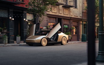 El Tesla Cybercab 2026 posa con su innovador diseño y puertas de ala de gaviota abiertas.