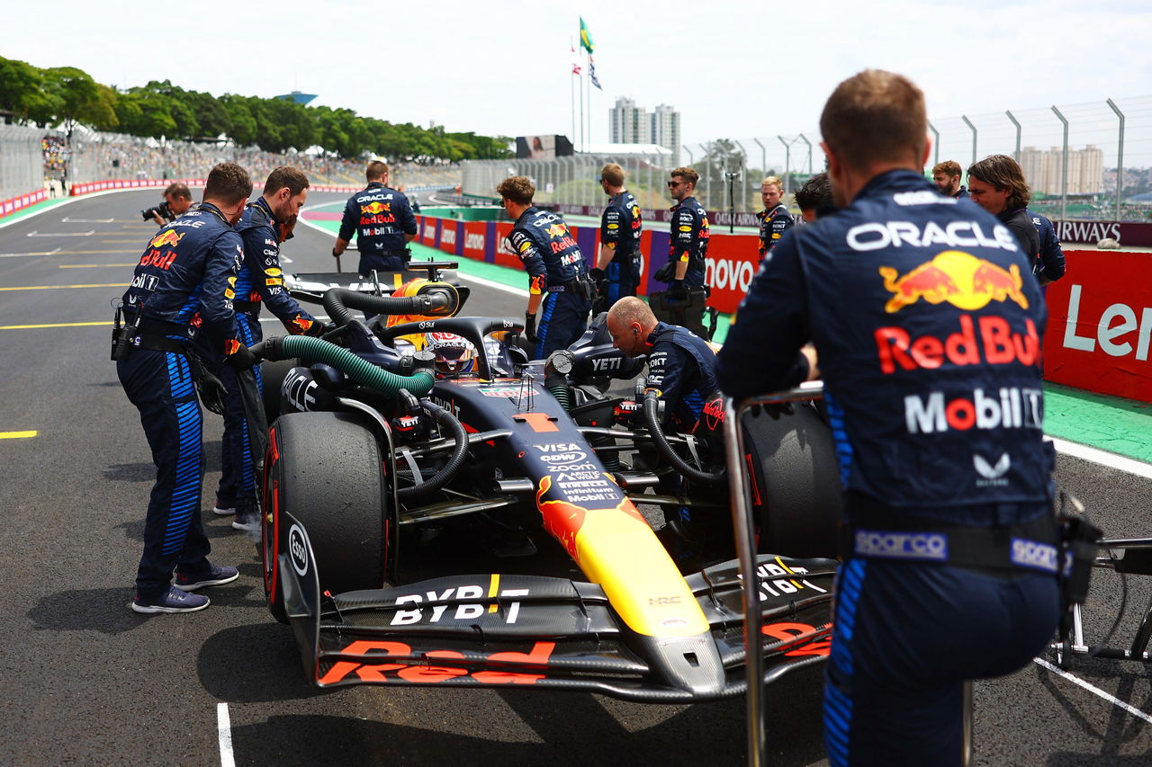 Un monoplaza de F1 de Red Bull en el pit lane con equipo técnico.