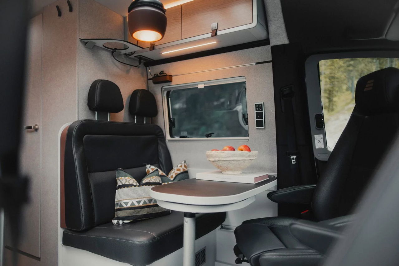 Vista interior de la camper 4x4, destacando sus asientos ergonómicos y acabados de lujo.