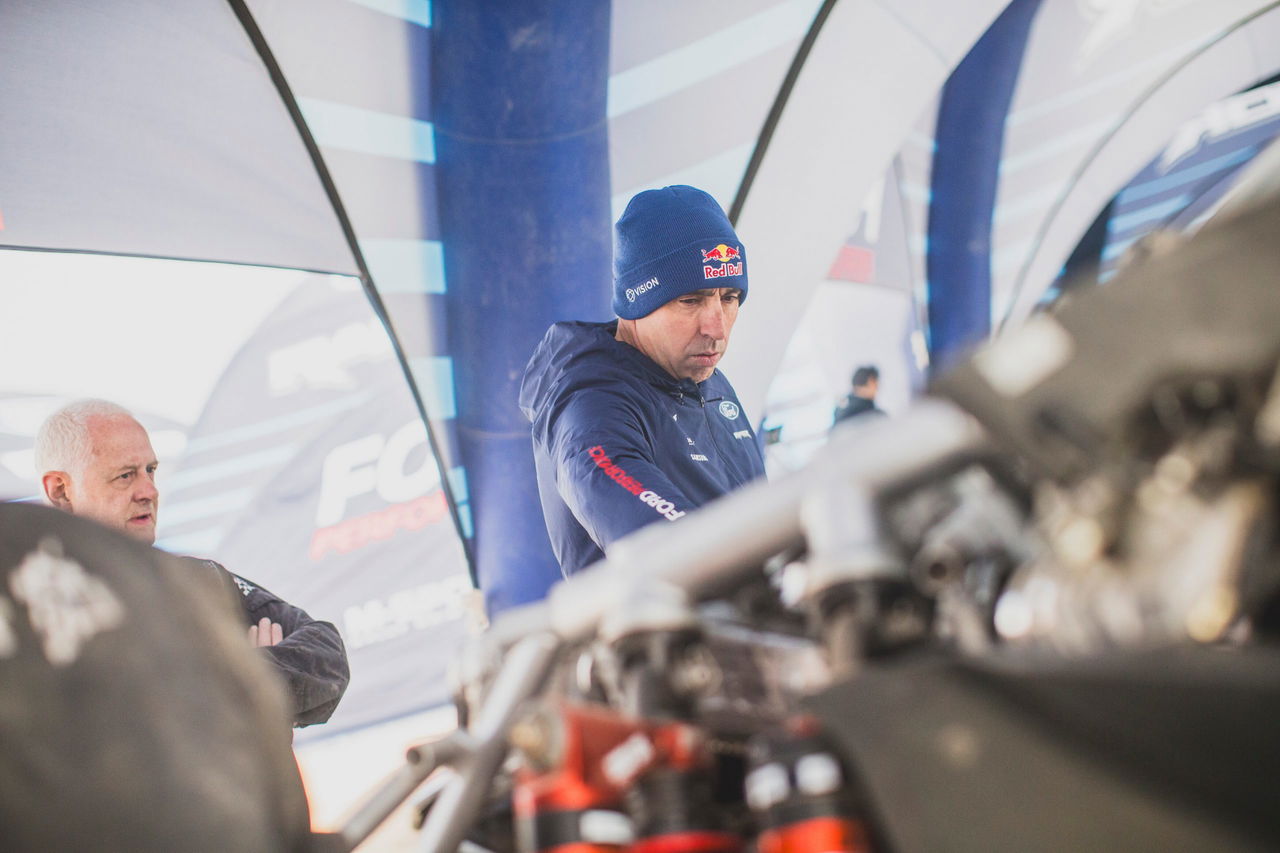 Imágenes del equipo técnico revisando detalles del coche de rally.