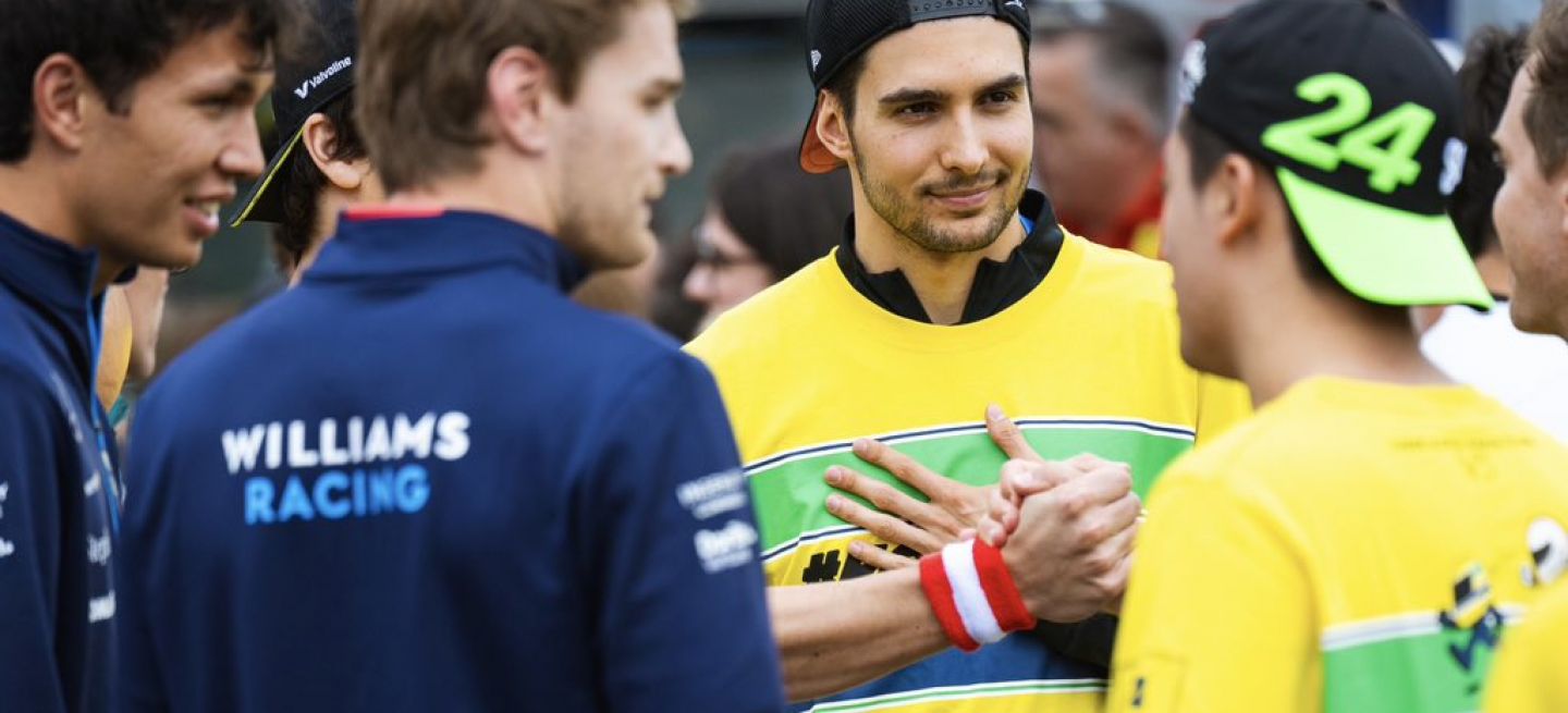 Esteban Ocon conversando con personal de equipos de F1.