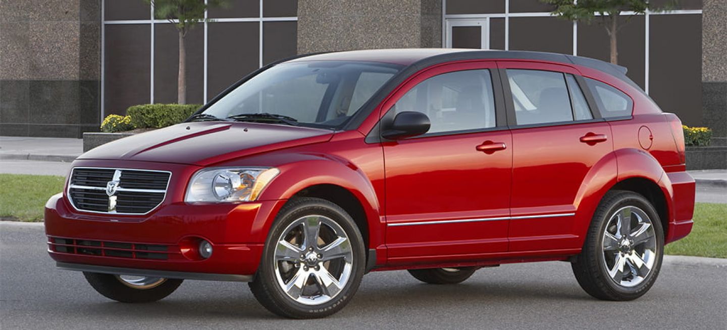 Vista lateral del Dodge Caliber en tonalidad roja, resaltando su diseño robusto.