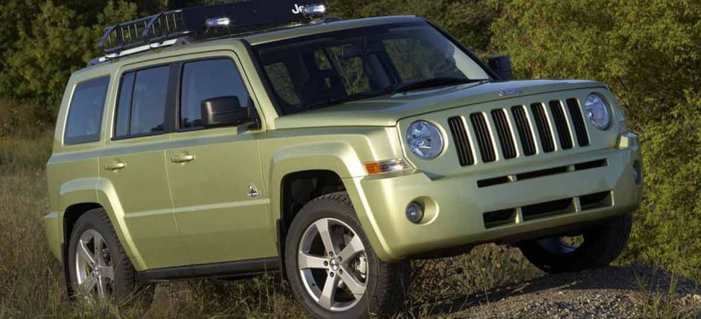 Vista lateral del Jeep Patriot en color verde destacando su línea robusta y aventurera.